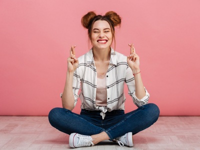 girl with crossed fingers for good luck