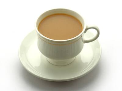 Cup of tea with milk on a white background